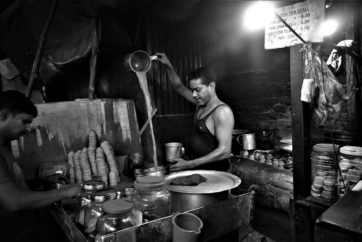 A man pouring tea at a roadside chai stall