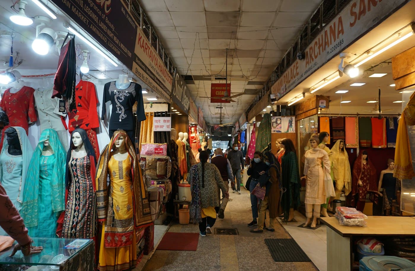 A clothing market corridor lined with kurtas and dresses