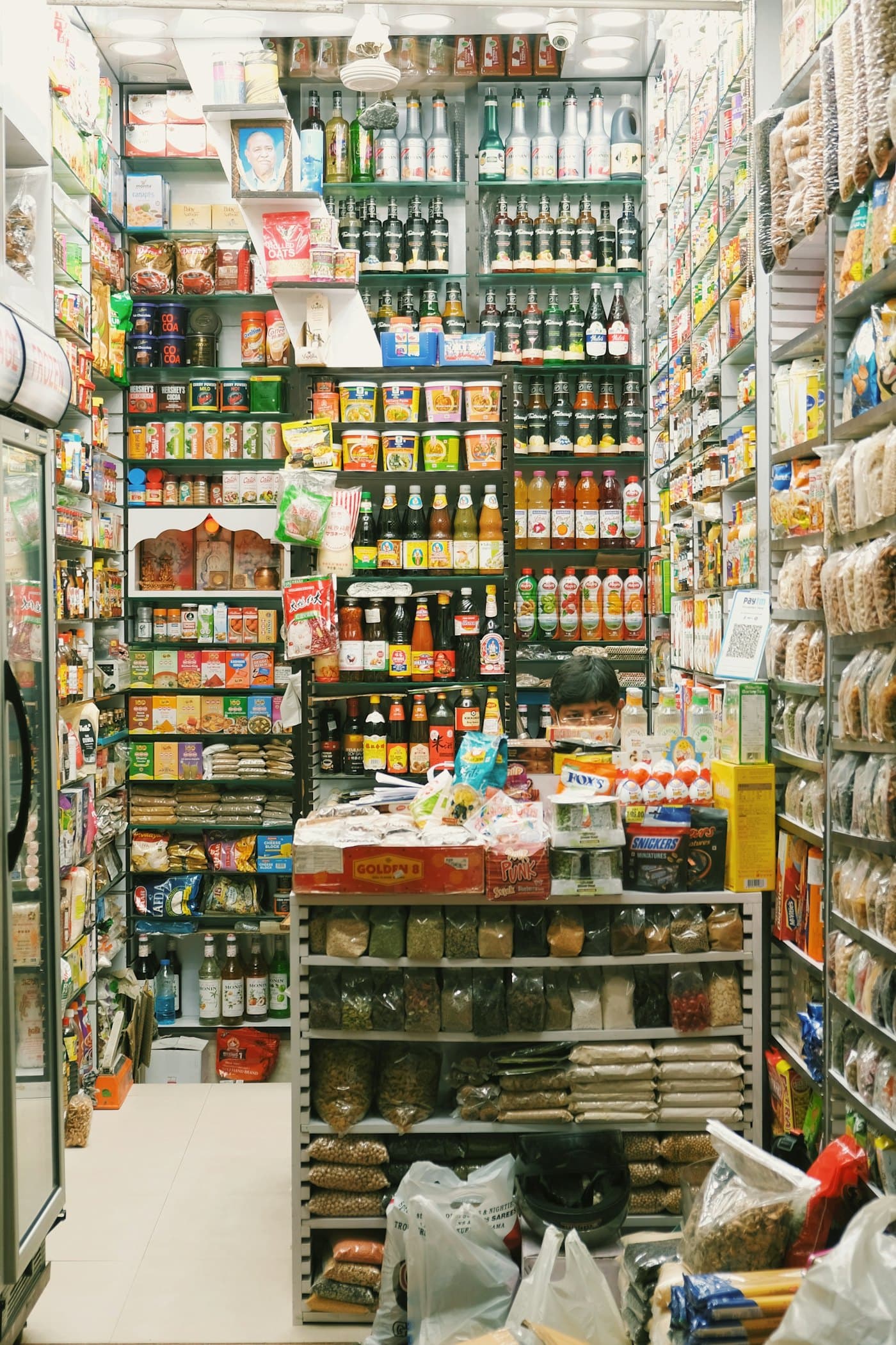 Shelves packed with snacks and groceries in a kirana store